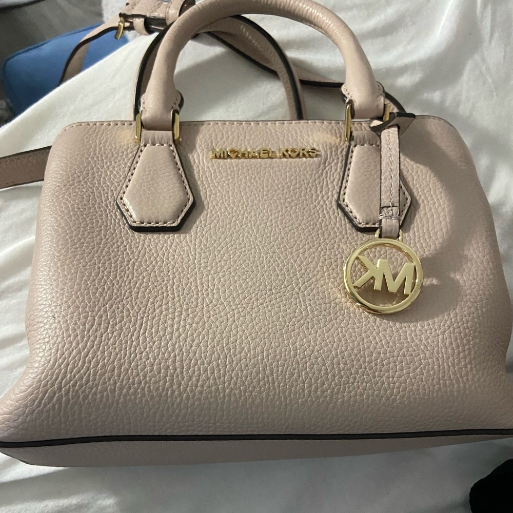 Pink Michael Kors purse with matching coin wallet.